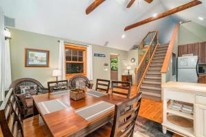 a dining room with a table and chairs and a staircase at The Stonewater Lodge in Traverse City