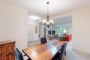 a dining room with a wooden table and chairs at Cardinal Corner in Glen Arbor