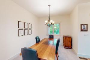 a dining room with a wooden table and chairs at Cardinal Corner in Glen Arbor