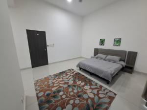 a bedroom with a bed and a rug at D'Aster Sara's Homestay Seremban-Malay Only in Seremban
