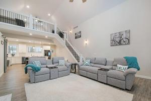 a living room with two couches and a staircase at Hidden Serenity in Sawyer