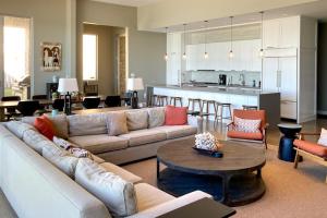a living room with a couch and a table and a kitchen at Leisure On The Lake in New Buffalo