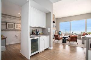 a kitchen with white cabinets and a living room at Leisure On The Lake in New Buffalo