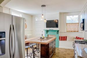 a kitchen with a refrigerator and a table in it at The Blacker House in Manistee