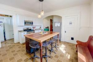 a kitchen with a wooden table and stools at The Blacker House in Manistee
