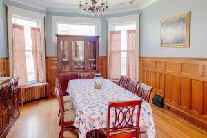 a dining room with a table and chairs and a chandelier at The Blacker House in Manistee