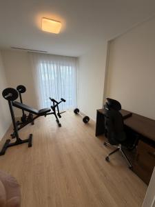 an office with two exercise bikes and a desk at OMA Residence in Ferizaj
