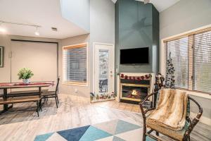 a living room with a table and a fireplace at Wintergreen Condo, Unit #543 in Thompsonville