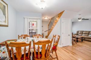 a living room with a table and chairs and a staircase at South Haven Heaven in South Haven