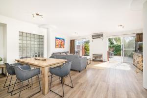 a living room with a table and chairs at Abby’s Beach Villa in Broadwater