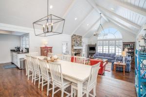 a kitchen and living room with a table and chairs at Point Cottage at Point O' Woods in Benton Harbor