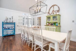 a dining room with a white table and chairs at Point Cottage at Point O' Woods in Benton Harbor +27 photos