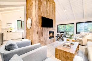 a living room with a couch and a fireplace at Dune House in Manistee