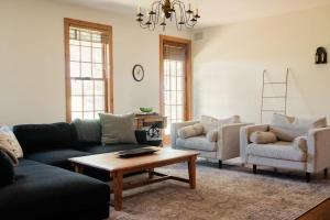 a living room with couches and a coffee table at Sorellina House in Maple City