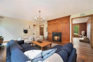 a living room with a blue couch and a fireplace at Sorellina House in Maple City