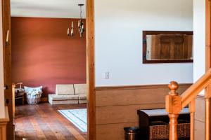 a hallway with a living room with a couch at Sorellina House in Maple City +58 photos