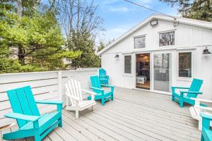 a group of blue chairs sitting on a deck at The Gatehouse on Orchard Beach in Lakeside