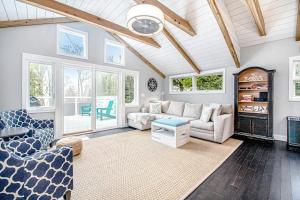 a living room with a couch and a table at The Gatehouse on Orchard Beach in Lakeside