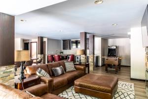 a living room with a couch and a kitchen at Mac's Bluff in Grand Beach
