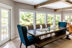 a dining room with a wooden table and chairs at Mac's Bluff in Grand Beach