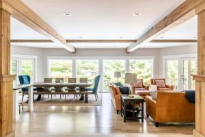 a living room with a ping pong table and chairs at Mac's Bluff in Grand Beach