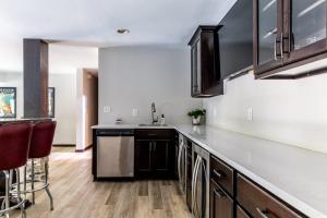 a kitchen with a sink and a counter top at Mac's Bluff in Grand Beach +27 photos