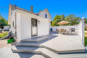 a white house with a deck and a patio at Harbor Charm in Harbor Springs