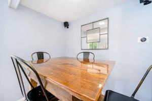 a dining room table with chairs and a window at Harbor Charm in Harbor Springs +16 photos