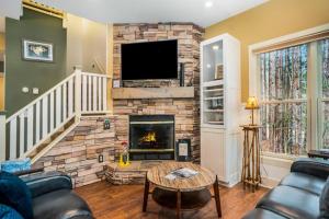 a living room with a fireplace and a tv at Beach House in Saugatuck