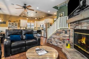 a living room with a couch and a fireplace at Beach House in Saugatuck +31 photos