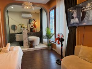 a room with a bathroom with a tub and a sink at Romance Hotel in Ho Chi Minh City +21 photos
