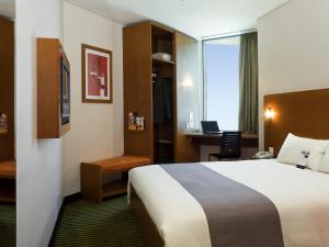 a hotel room with a bed and a desk at ibis Amman in Amman +102 photos