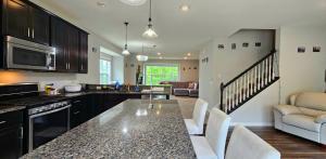 a kitchen with a table and chairs in a room at River Valley Stay in Eagan