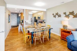 a kitchen and dining room with a table and chairs at The Sanctuary - Summer Breeze A114 in Virginia Beach