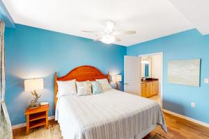 a blue bedroom with a bed and a ceiling fan at The Sanctuary - Summer Breeze A114 in Virginia Beach +20 photos
