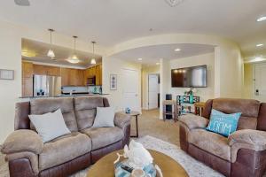 a living room with two couches and a kitchen at The Sanctuary - Blue Lagoon A323 in Virginia Beach