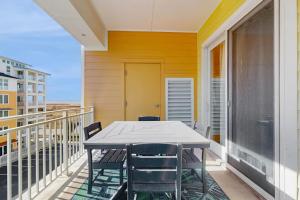 a balcony with a table and chairs on it at The Sanctuary - Blue Lagoon A323 in Virginia Beach
