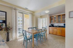 a kitchen and dining room with a table and chairs at The Sanctuary - Blue Lagoon A323 in Virginia Beach