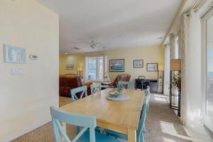 a dining room and living room with a table and chairs at The Sanctuary - Blue Lagoon A323 in Virginia Beach