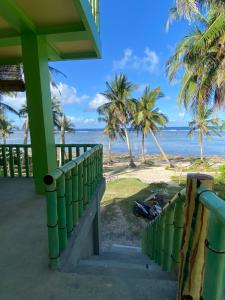 a view of the beach from the porch of a resort at Kapunoan Beach House in Burgos