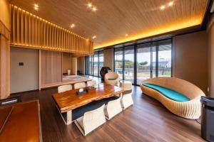 a living room with a wooden table and chairs at 貞芙庵 in Ichinomiya