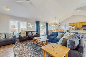 a living room with blue couches and a table at Down By The Sea in Virginia Beach