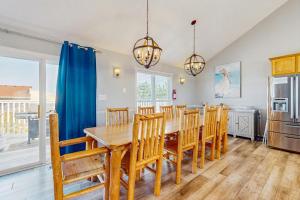 a dining room with a table and chairs at Down By The Sea in Virginia Beach