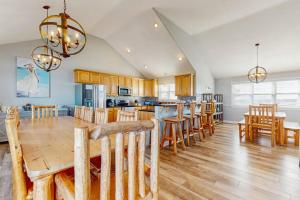 a kitchen with a large wooden table and chairs at Down By The Sea in Virginia Beach