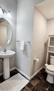 a bathroom with a sink and a toilet and a mirror at River Valley Stay in Eagan
