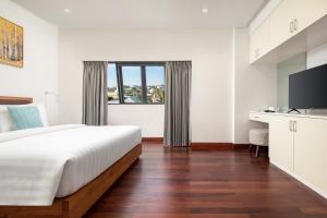 a bedroom with a large bed and a television at Angkor Mansion & Apartment in Siem Reap +46 photos