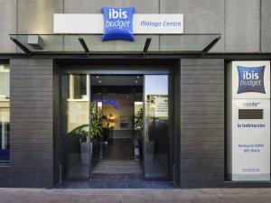 a building with a sign on the door of aubs buffet center at Ibis Budget Málaga Centro in Málaga