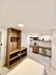 a kitchen with wooden shelves and a desk in a room at Premium Office-My Stay 09 in Brasília