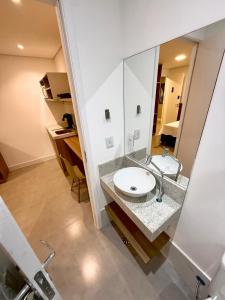 a bathroom with a sink and a mirror at Premium Office-My Stay 09 in Brasília +34 photos