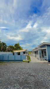 a row of houses with a blue fence at Hureen chalet hmk in Kangar
